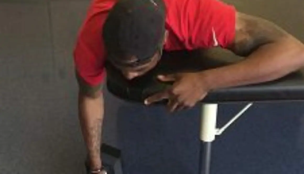 Man lying on bench lifting weights