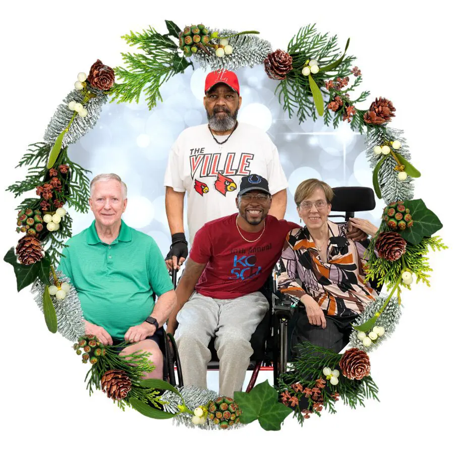 A group of four people with spinal cord injuries encircled by a winter wreath.