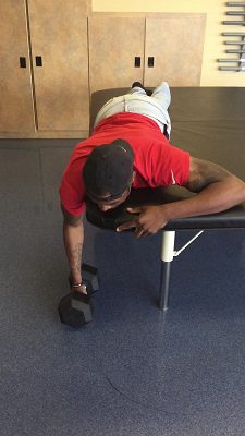 Man lying on bench lifting weights