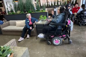 Guests, some using wheelchairs, mingling in a beautifully decorated and inclusive space.