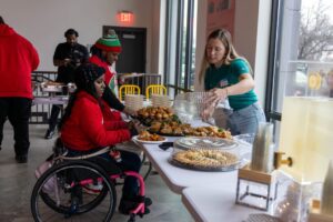 Attendees serving themselves food from a buffet line.